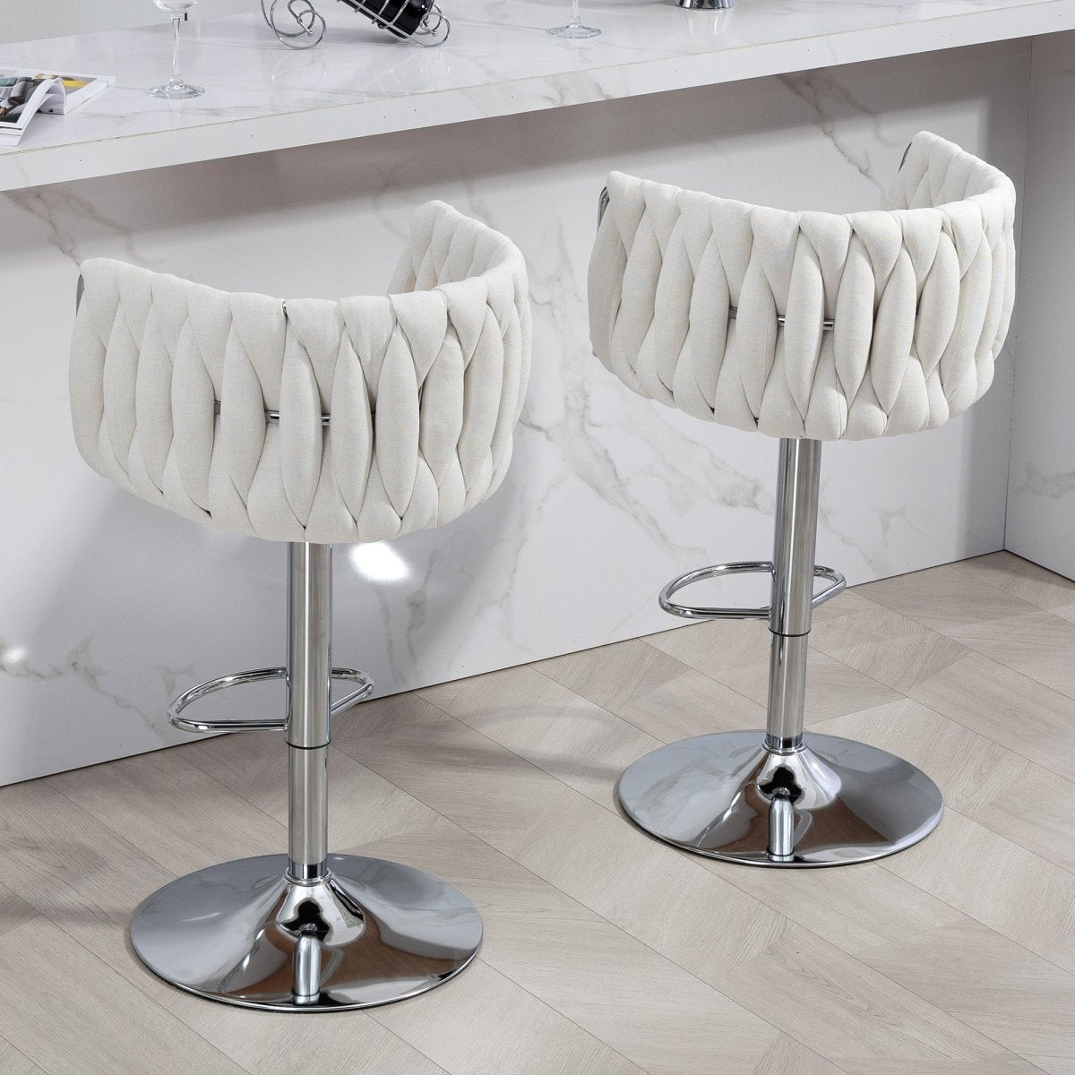 w2215p184992 - Rear view of two beige woven-back bar stools at a marble counter