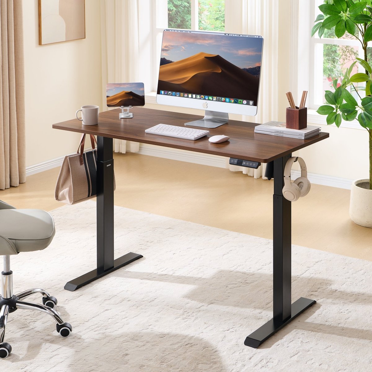 Walnut-look electric standing desk in a bright window-side home office