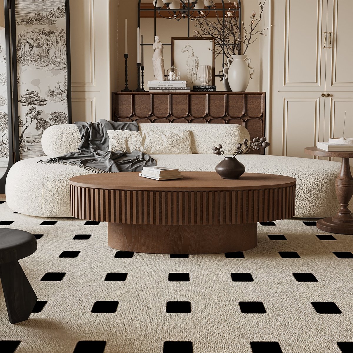 Front lifestyle view of the walnut oval coffee table closed in front of a curved cream sofa.