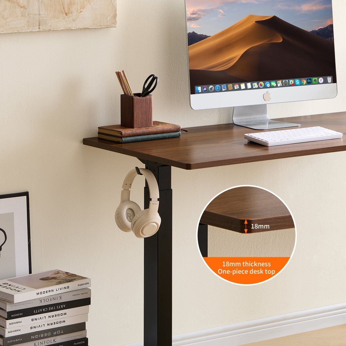 Electric standing desk arranged as a compact bedroom workspace
