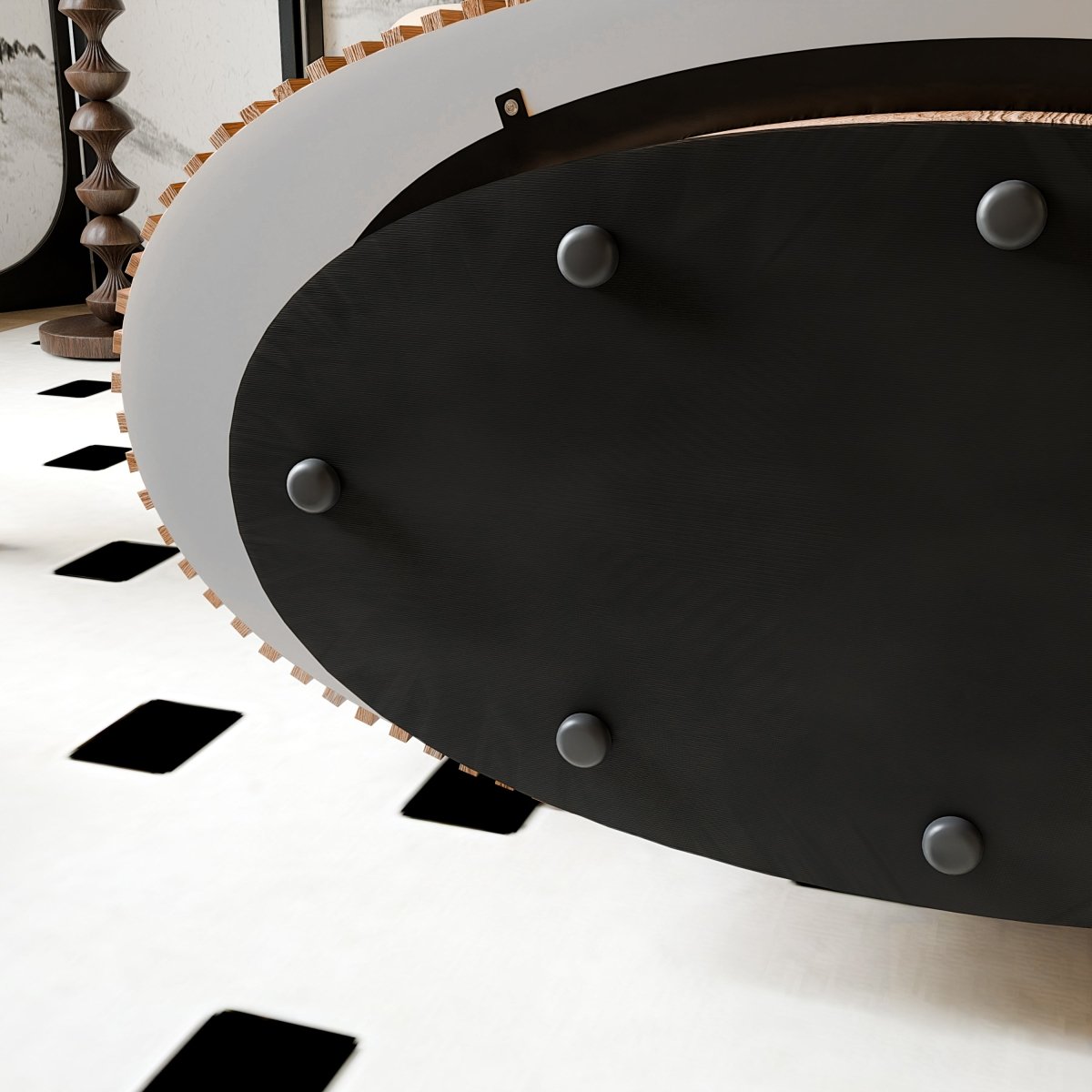 Underside view of the oval coffee table showing the dark base panel and round floor-contact pads.
