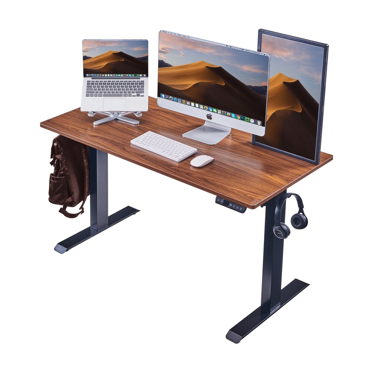 Electric standing desk set up with monitor, laptop, bag, and headphones