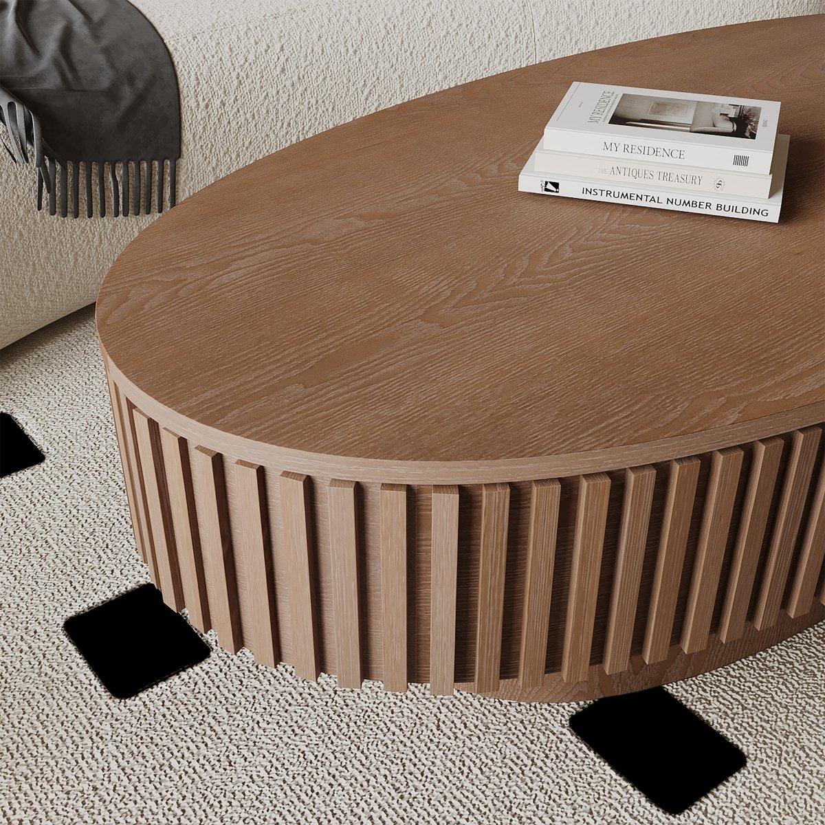 Close-up of the walnut coffee table top showing visible wood grain and vertical fluted detailing along the side.