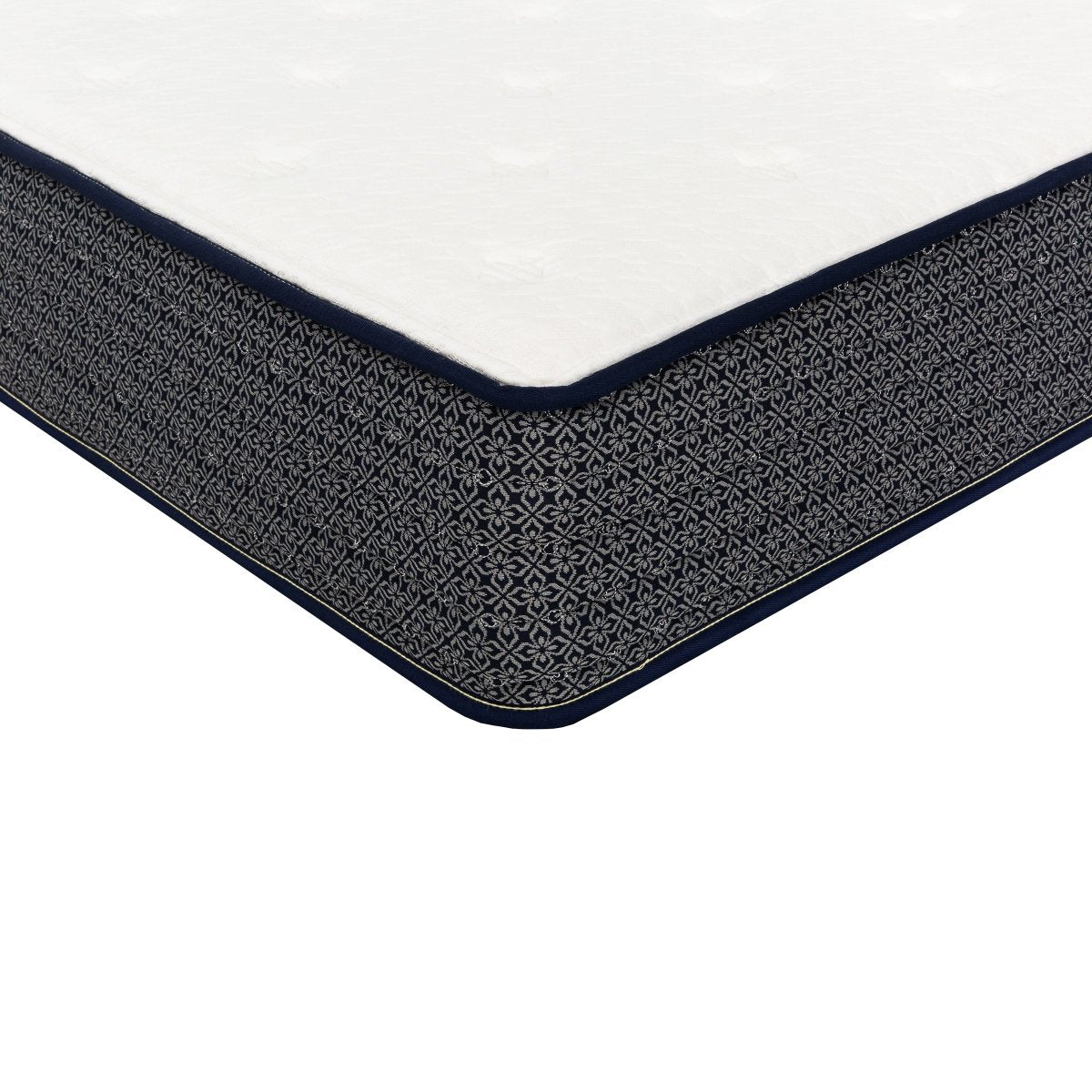 Corner detail of the Polar Hybrid TT queen mattress showing the white cover, navy piping and patterned side panel.